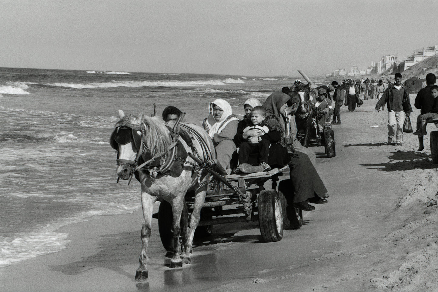 People in Gaza forced to travel on the beach while the coastal road is completely prohibited and blocked, 2003, by Joss Dray