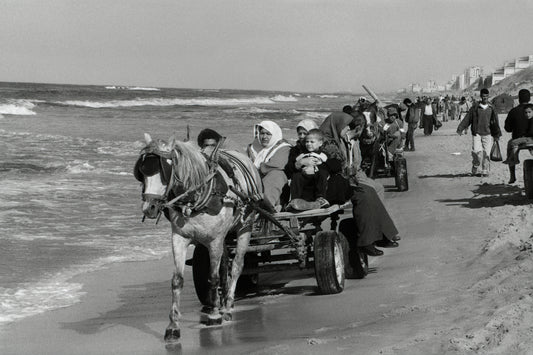 People in Gaza forced to travel on the beach while the coastal road is completely prohibited and blocked, 2003, by Joss Dray